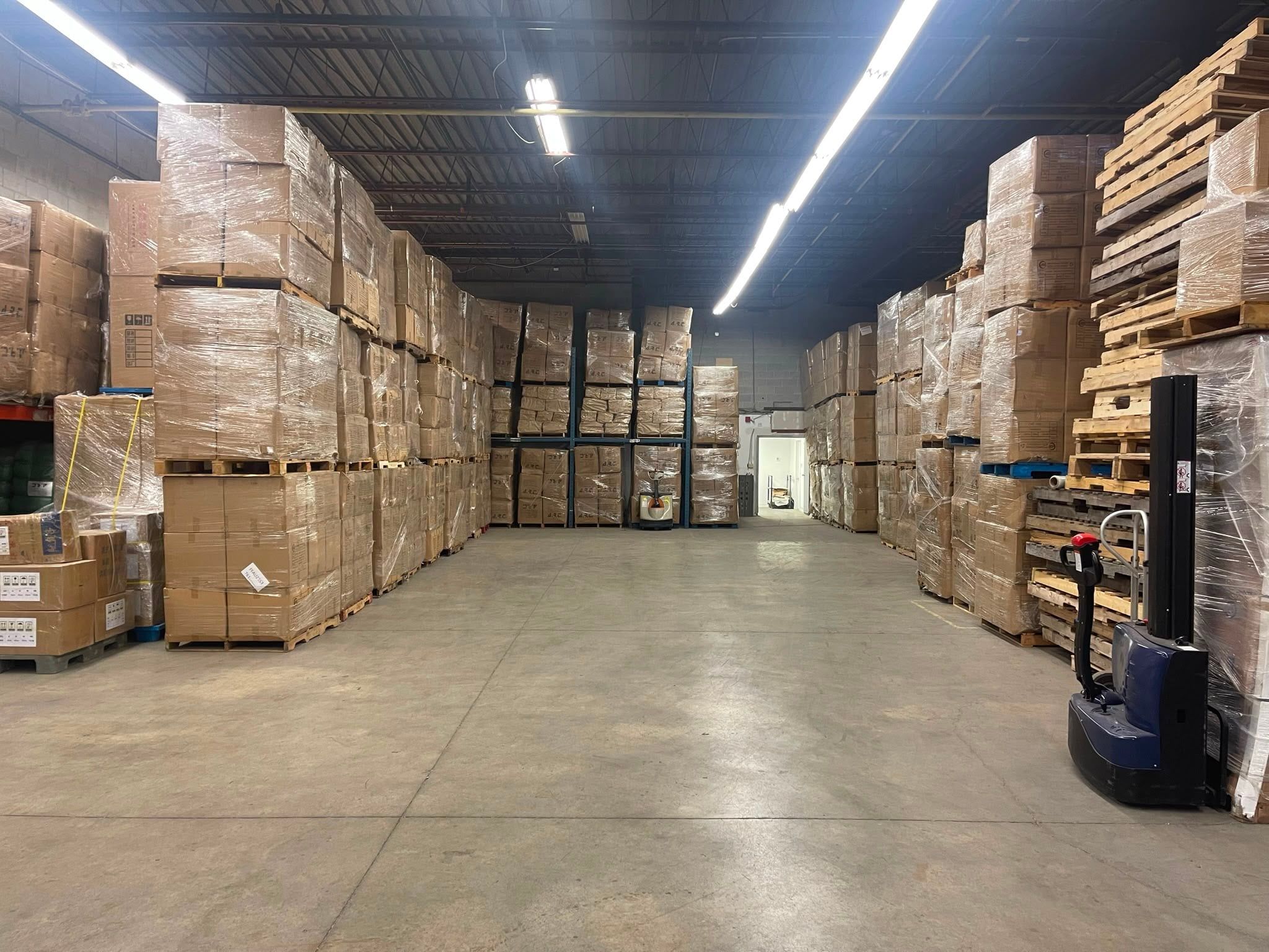 Pallets stacked high along a wide aisle in our Scarborough warehouse
