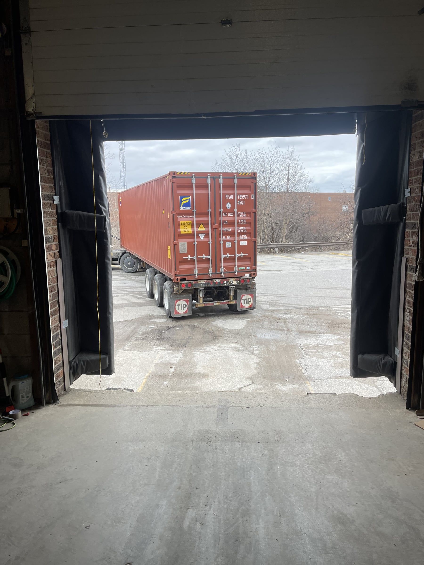 A container on its chassis, lined up with our open dock door